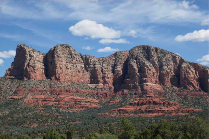 view of green and red rock mountains on a nice day