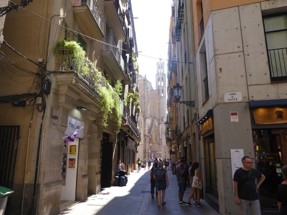 sunlight shining through a back alley of barcelona spain