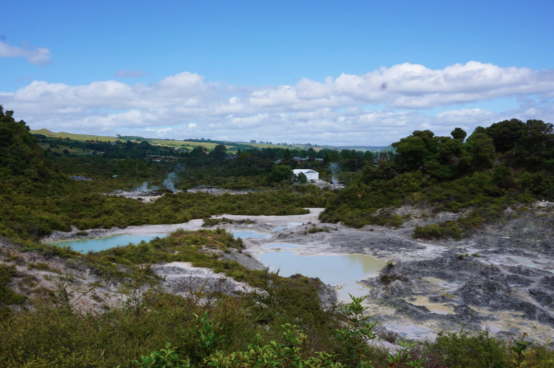 pretty blue lake hike with green trees around the water