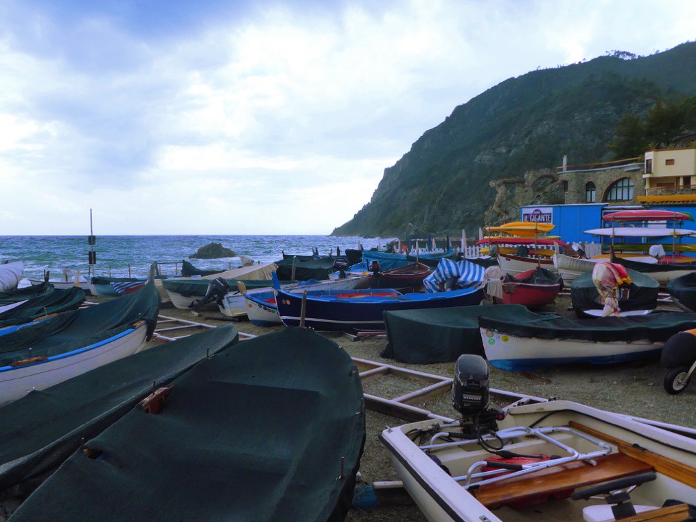 boats stored together on a beach of monterosso al mare