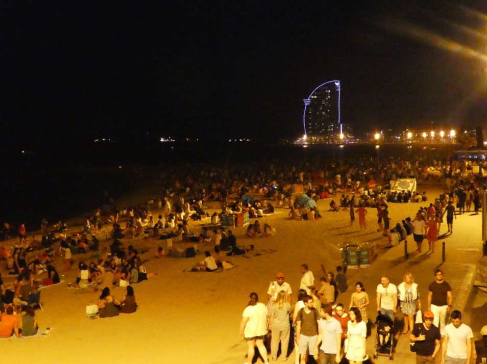 crowded beaches of barcelona at night during the festival of lights