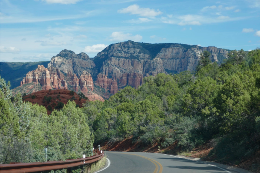 road cutting through the red rock mountains of sedona