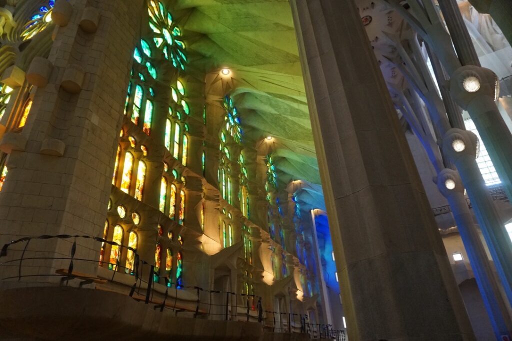 natural green and blue light shining into the sagrada familia through the stained glass