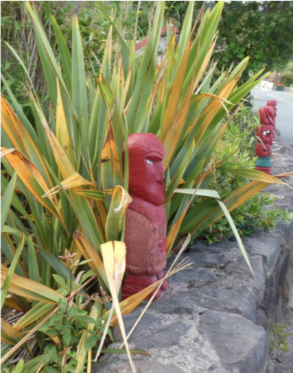 whakarewarewa red statue of a man