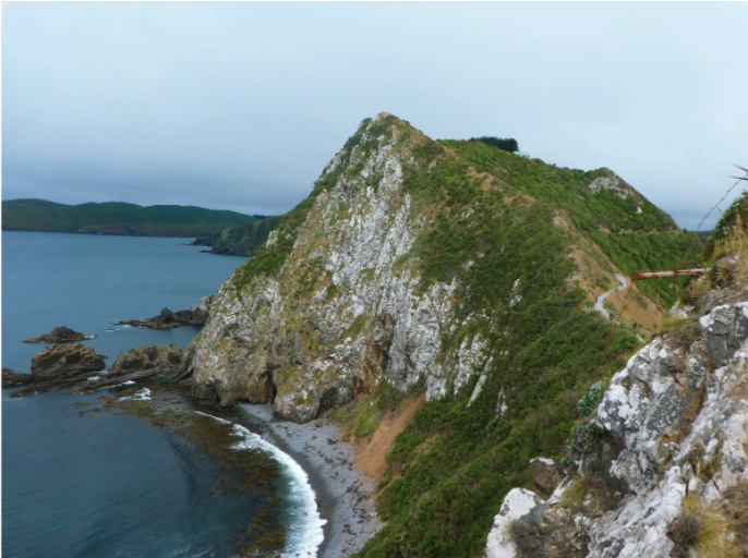 steep rock mountain by ocean