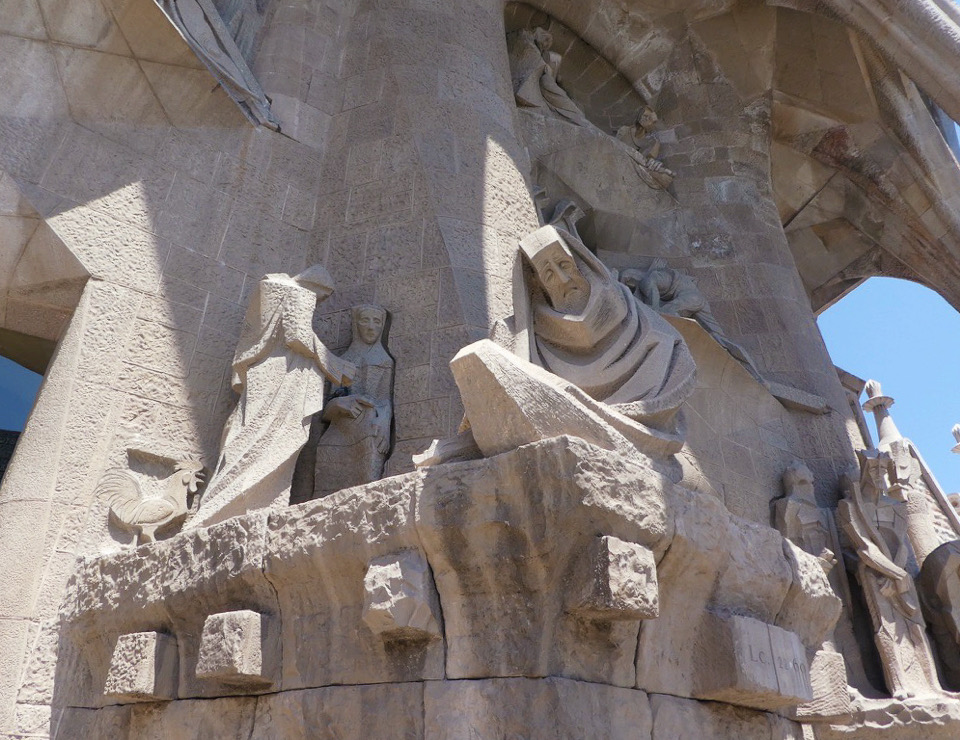 sad crying statues on the exterior of the sagrada familia