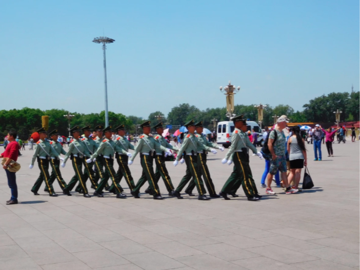 police squad walking through tiananmen square in uniform