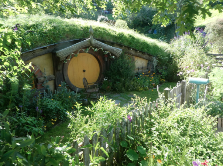 small hobbiton house with yellow door