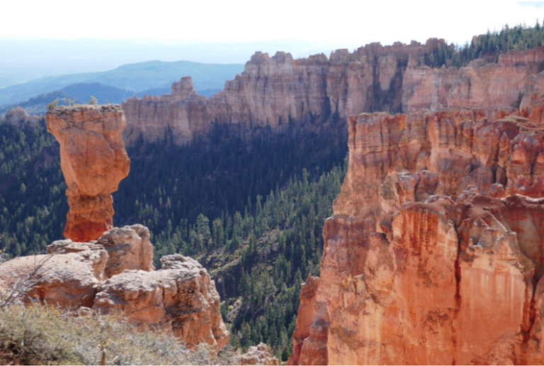 stunning lone rock tower balanced in front of green valley at agua canyon