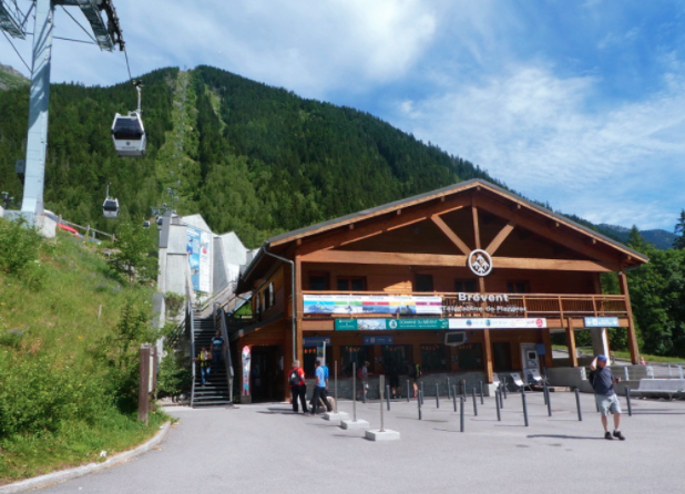 wooden gondola entrance with green mountain behind it