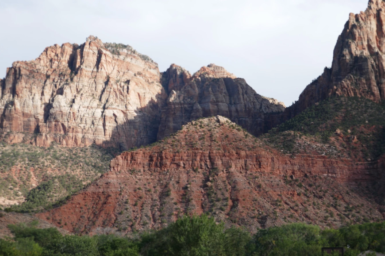 red rock mountain with shadows