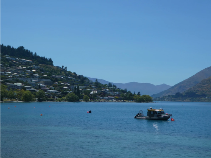 boat on the blue lake with trees in background