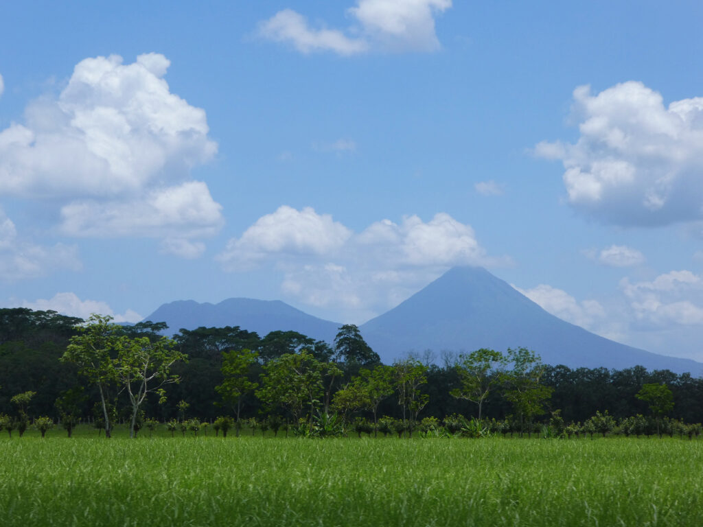 volcano with clouds and green trees