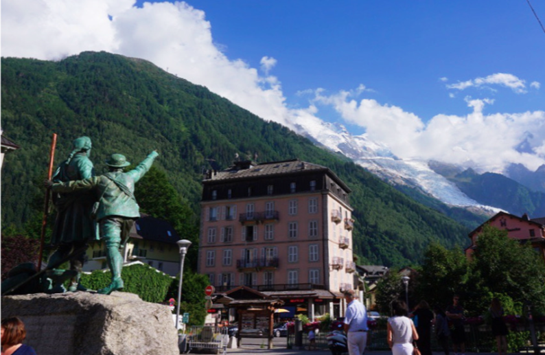 statue of saussure in chamonix pointing over a building