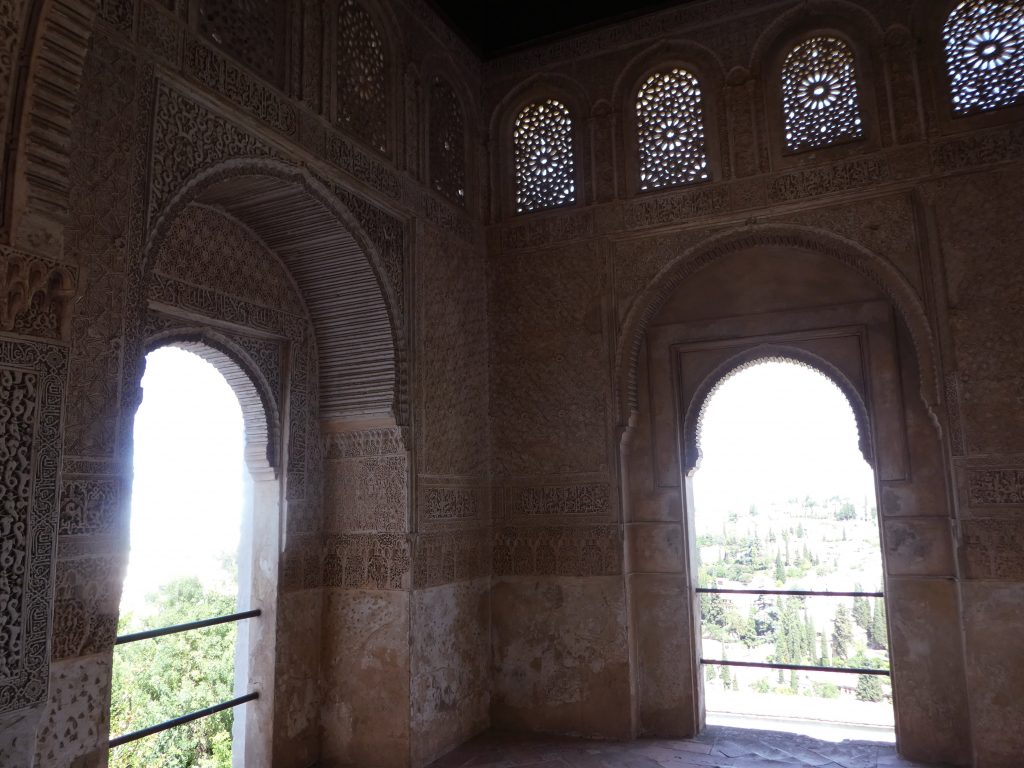 two arch windows at a corner that look out over the city of granada