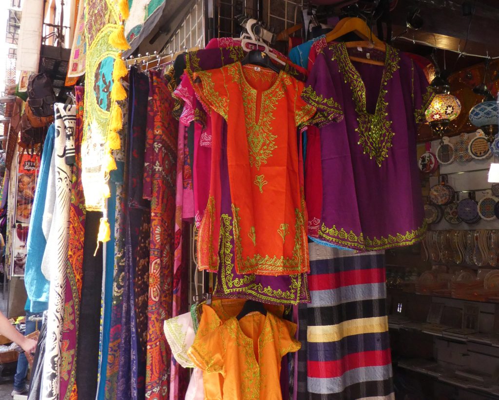 tourist shirts and gifts hanging in a doorway