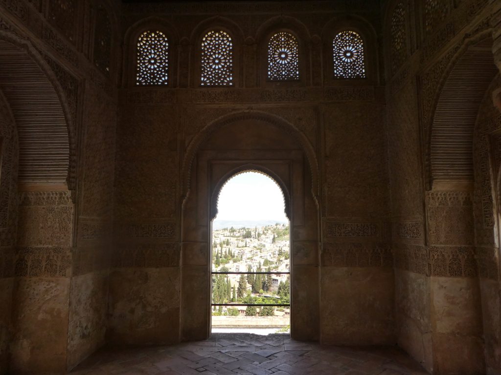 arches in the alhambra that looks out to the city