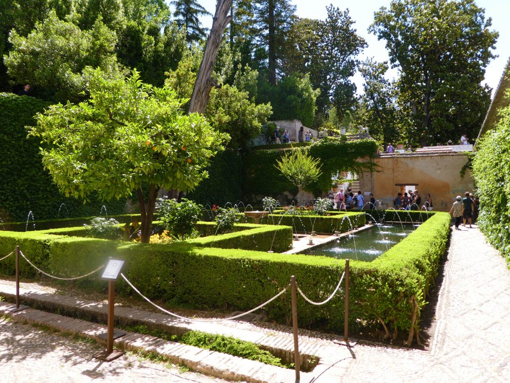 neatly cut green hedges with rope in front