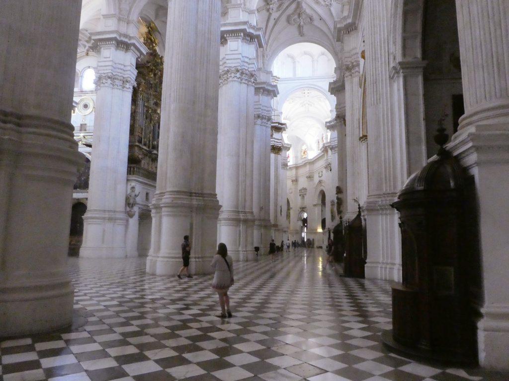 high arched white columns with a checkered tile floor