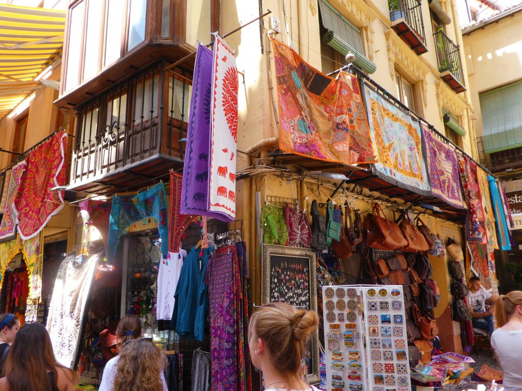 tapestries hanging down over a building in the street
