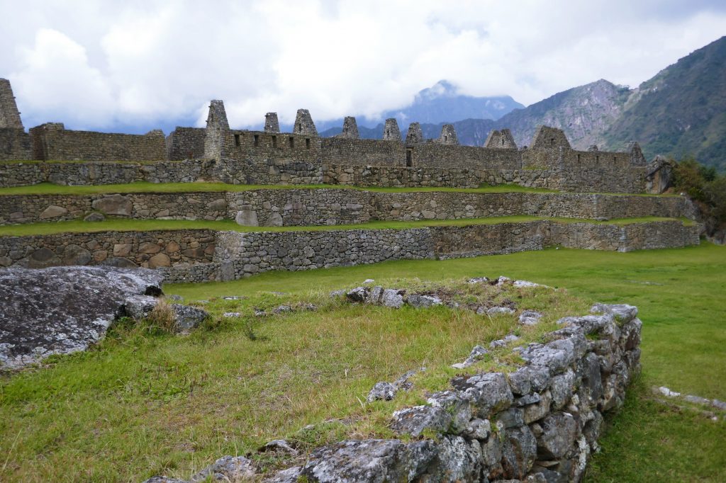 open green space between stone ruins
