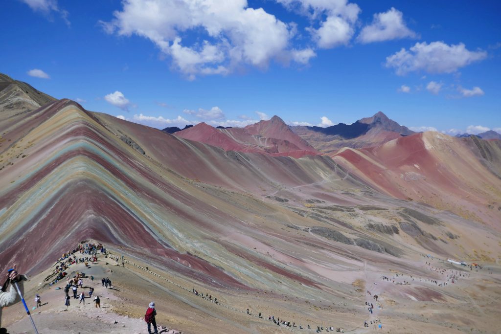 colorful painted mountains in the valley of the andes mountains with blue sky