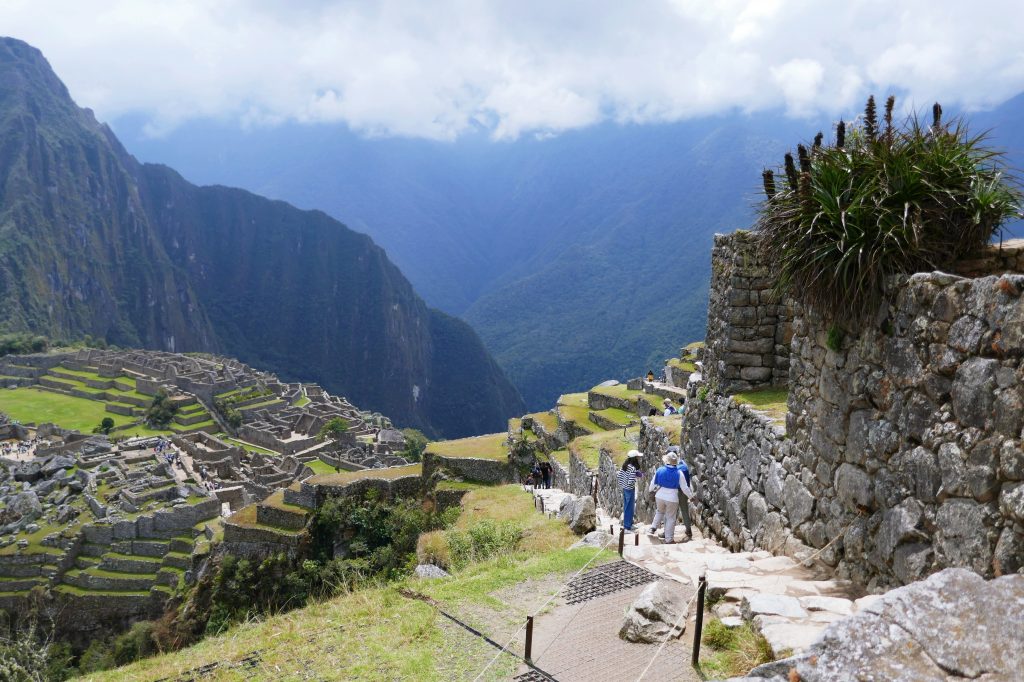 rocky path through machu picchu with people walking down it