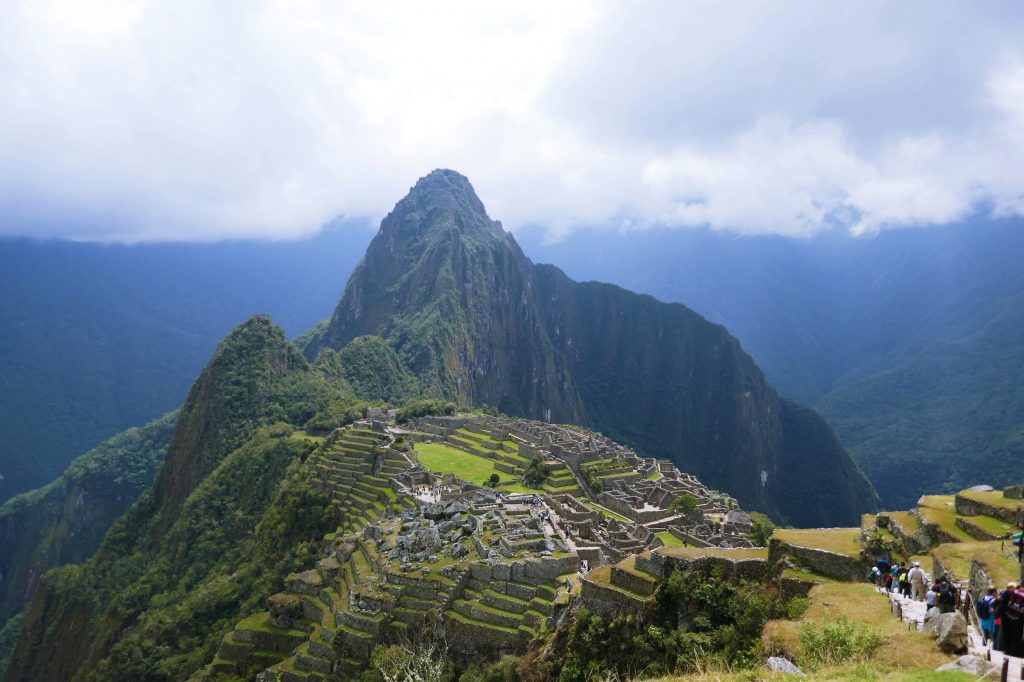 machu picchu on clear day with clouds in the background taken on a tour from cusco