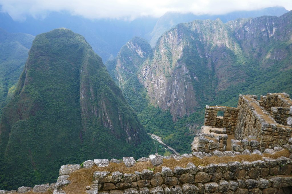 the view of the andes over a stone wall
