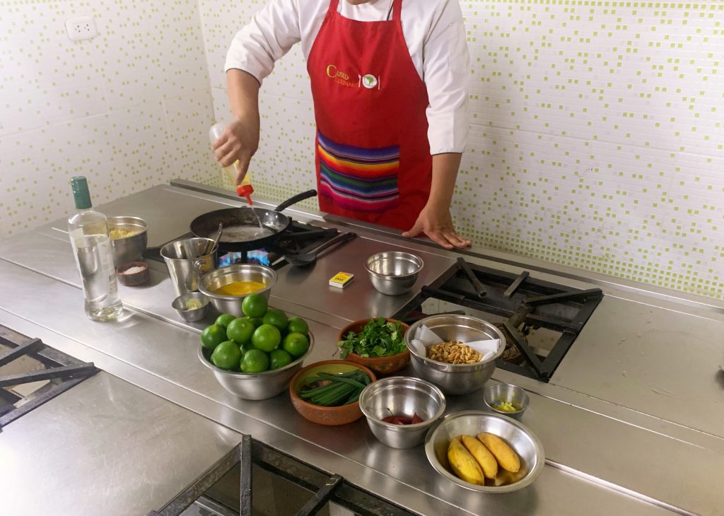 man putting oil on a pan with vegetables in a bowl