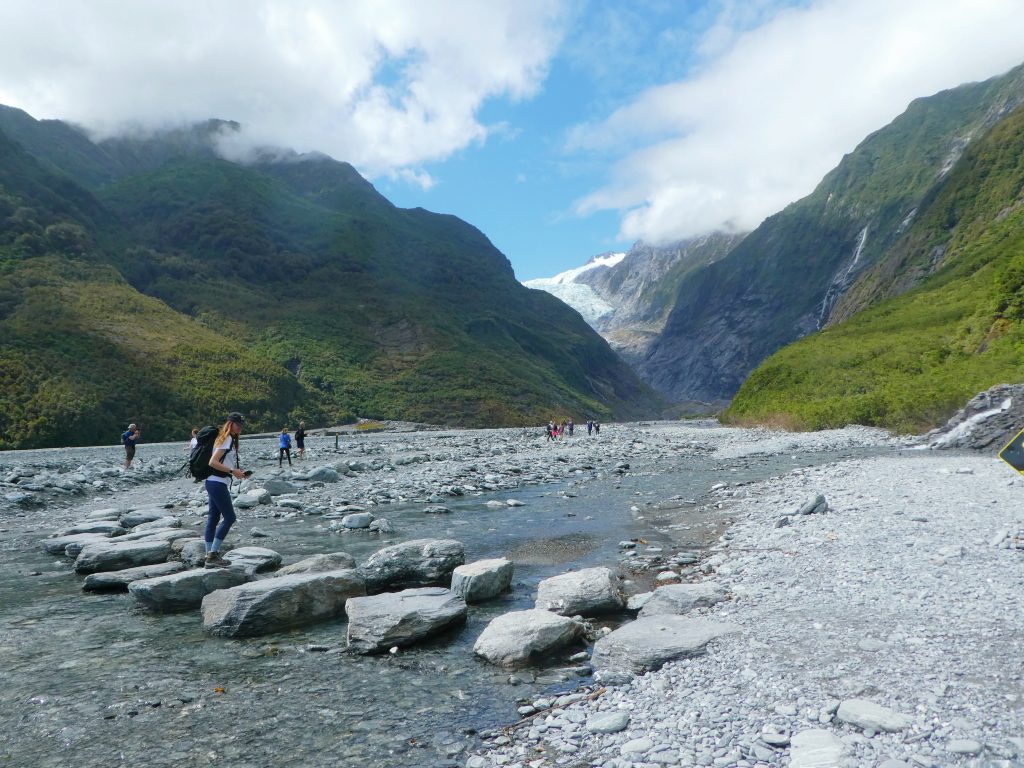natural rock bridge to walk over water on the hike to franz josef glacier