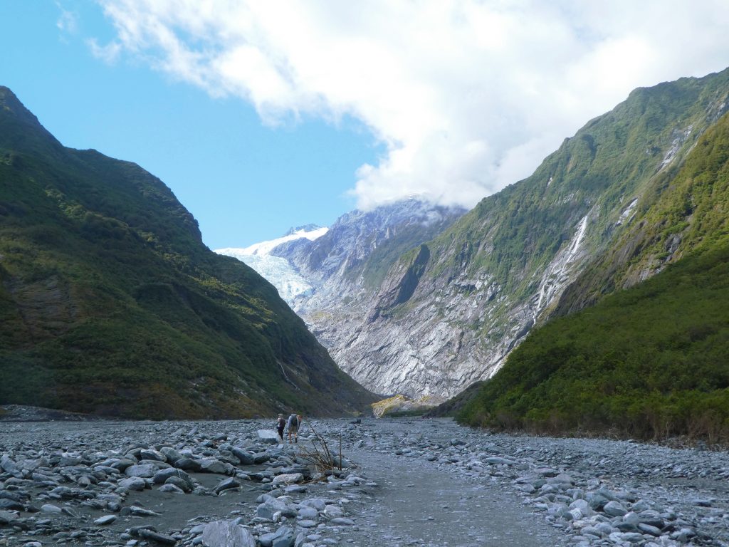 franz josef glacier peaking around the corner of a mountain
