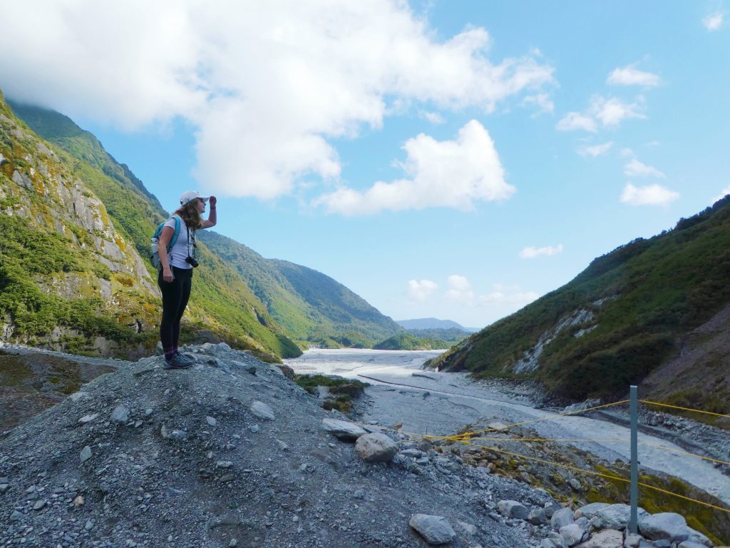girl pretending to lookout over valley