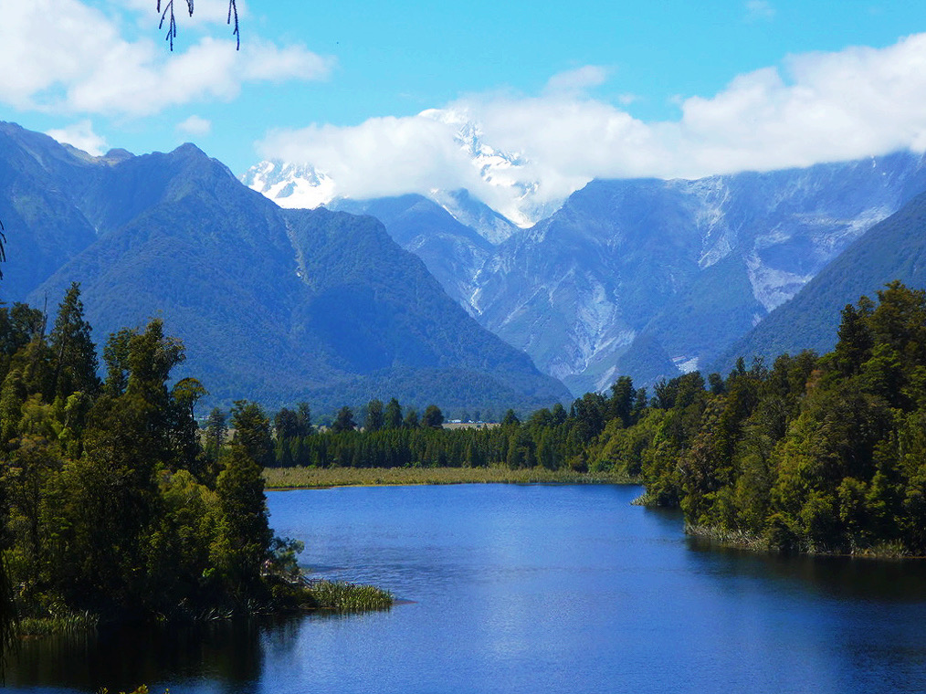snow covered mountain behind lake matheson