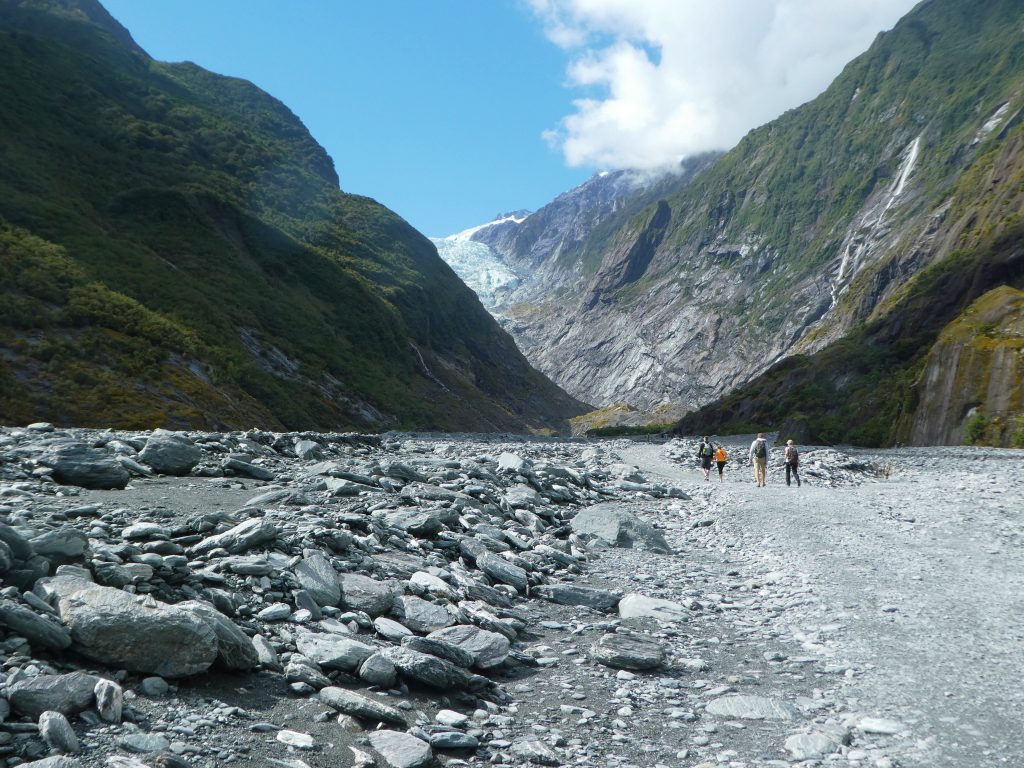 wide open stone valley beneath franz josef glacier