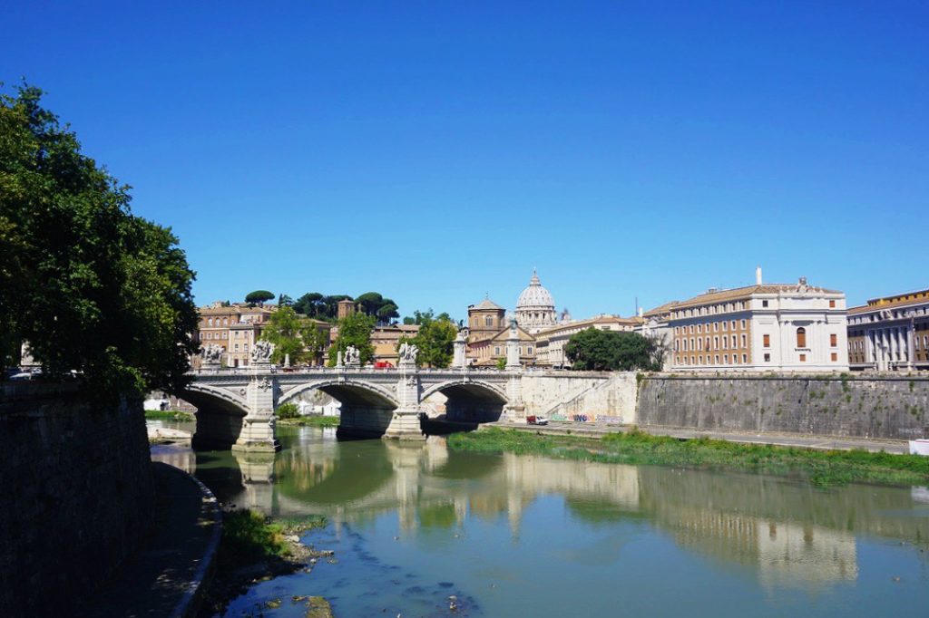 arched bridge running over a river