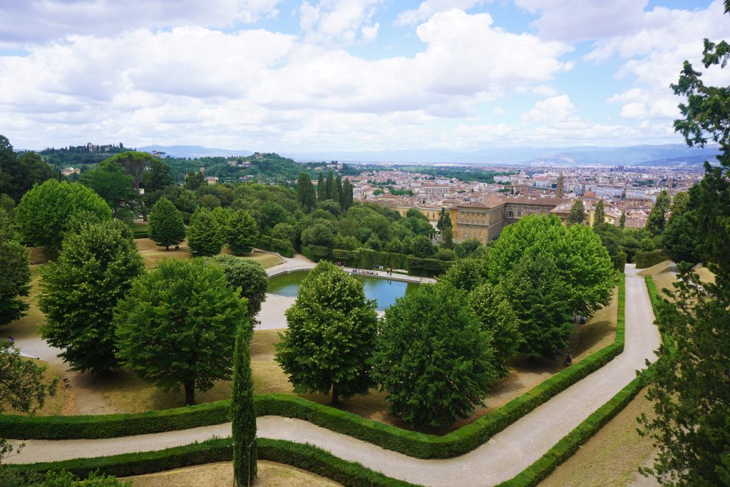 green walled garden with rows of trees