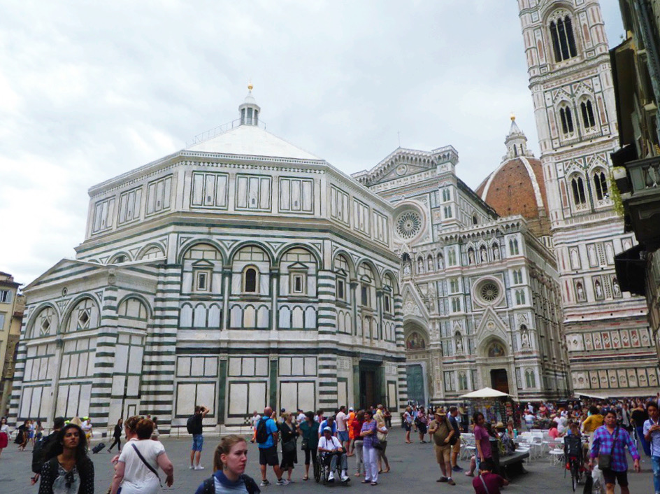 people walking in front of the piazza del duomo in florence