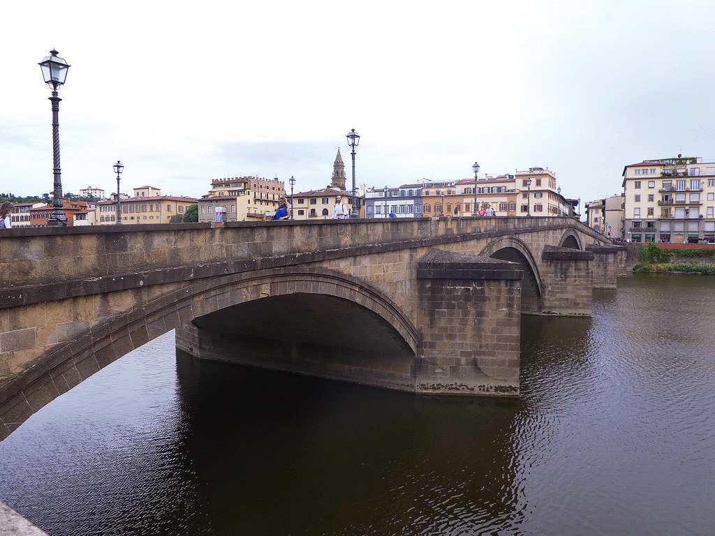 dirty bridge over the arno river in the middle of florence