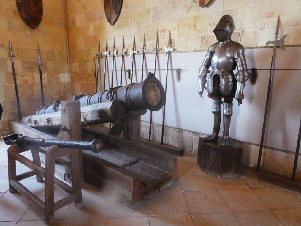 cannon and knight in shining armor in a stone room of the castle