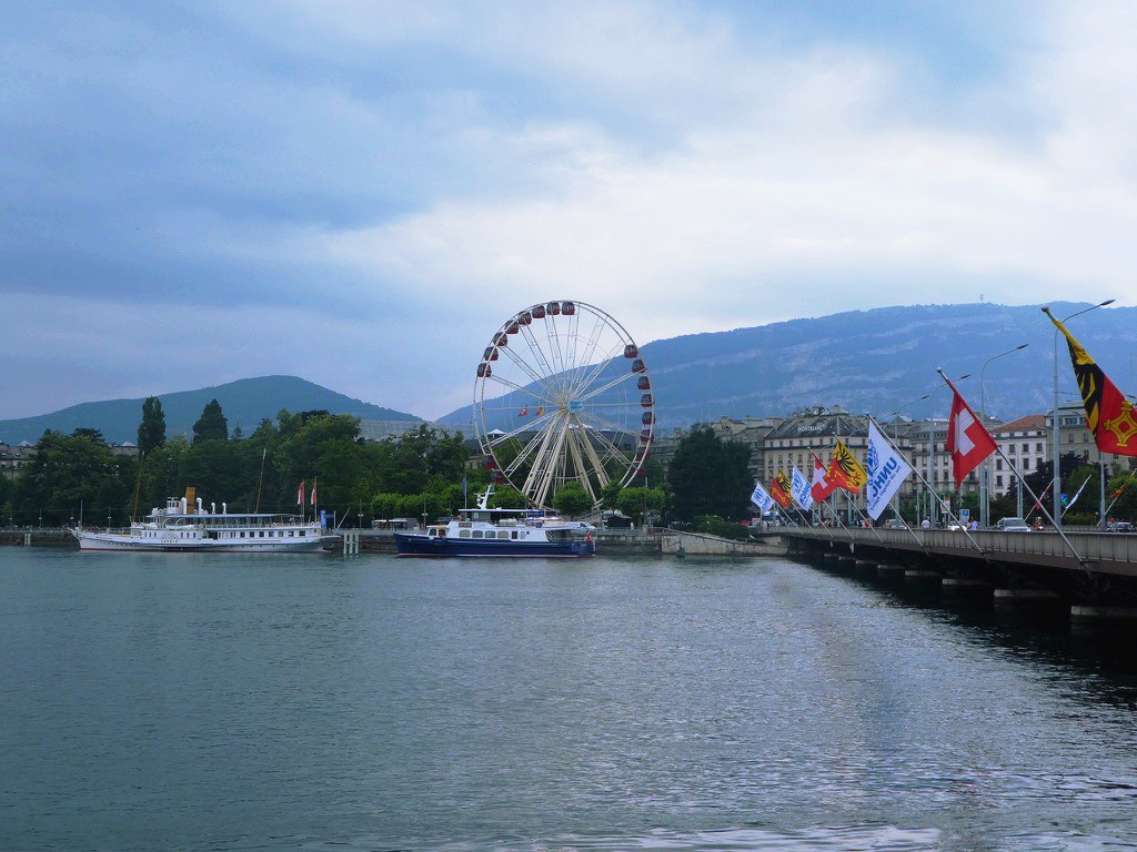 ferris wheel next to lake geneva