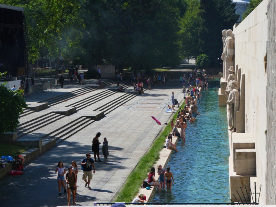 long pool with people sitting on the ledge