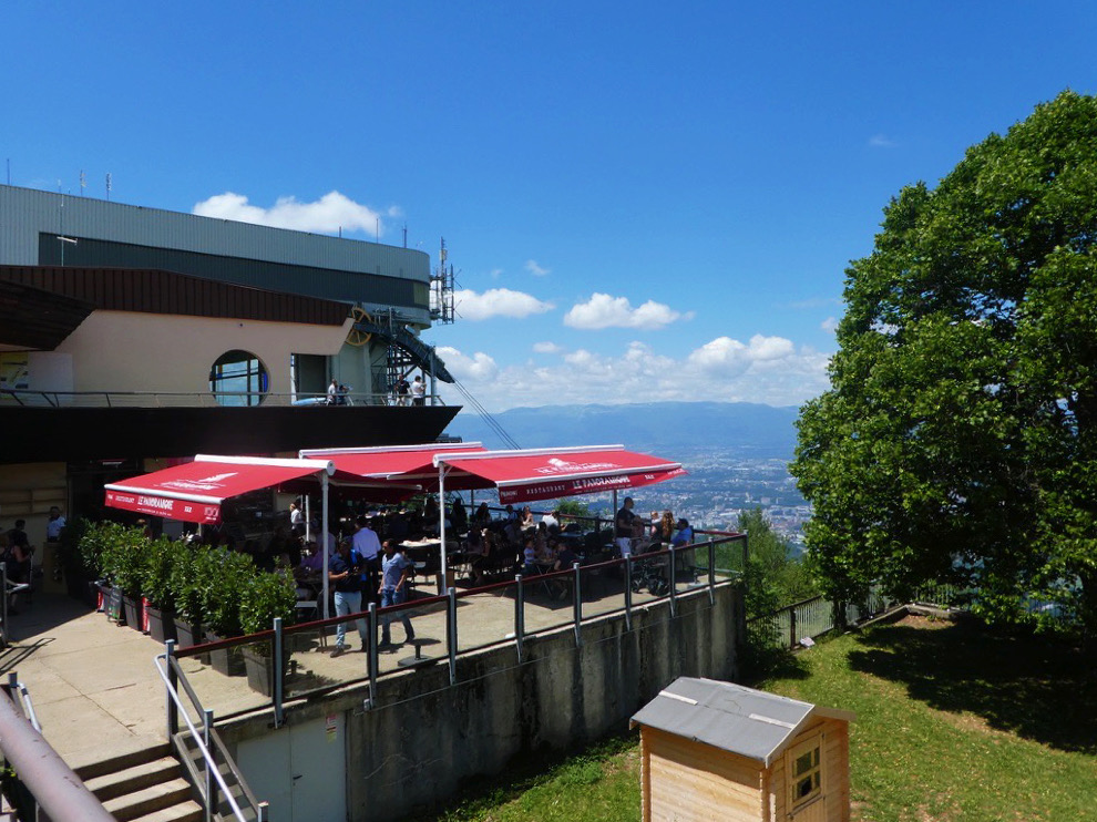 outdoor dining with red umbrellas on clear day
