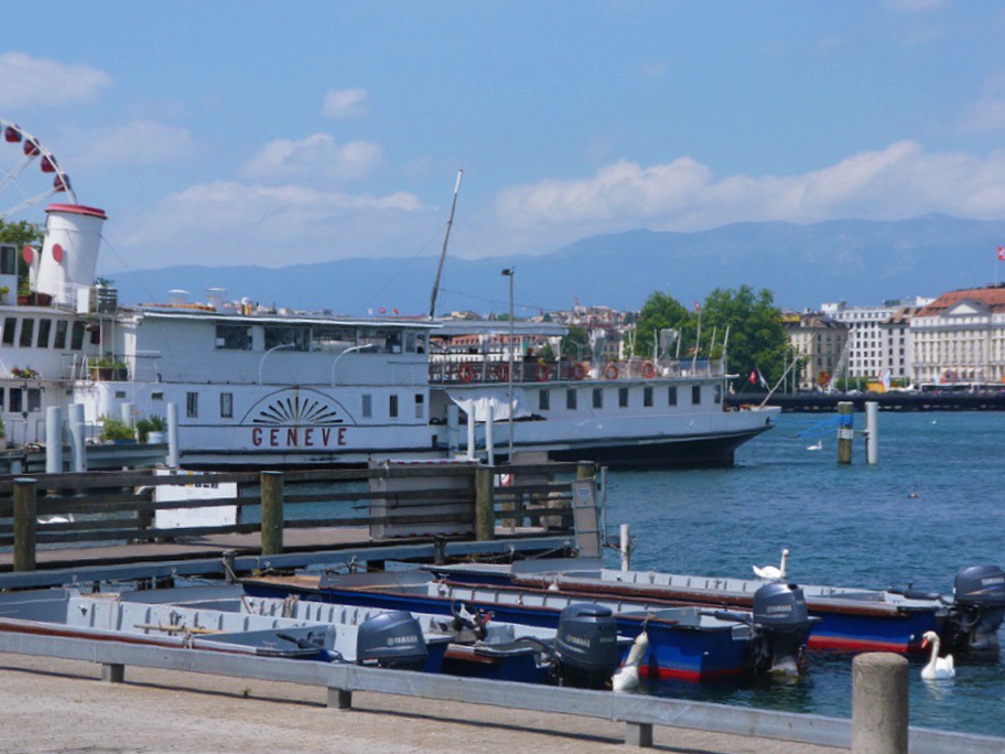 cruise boat parked next to dock on lake