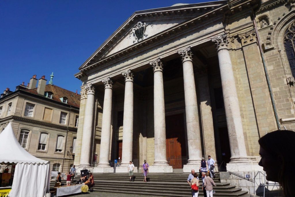 steps leading up to columns in front of the large wooden door of saint pierre cathedral