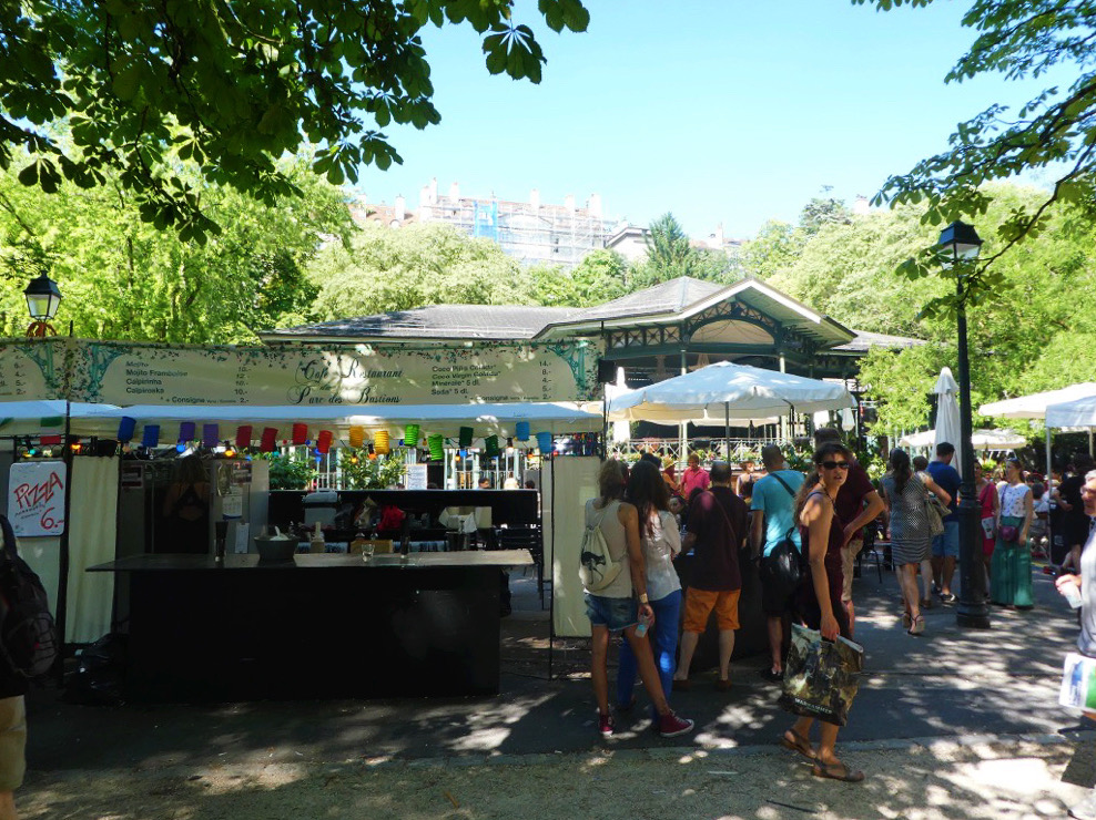 people crowding around outdoor shopping stands