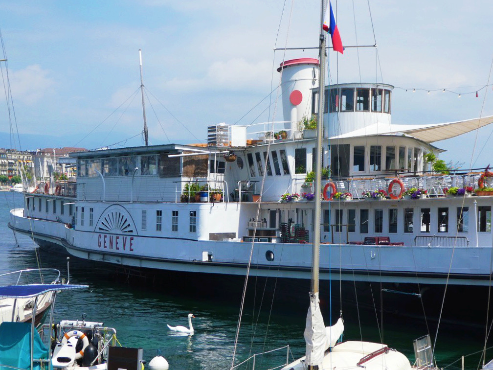 large white cruise boat with multiple floors