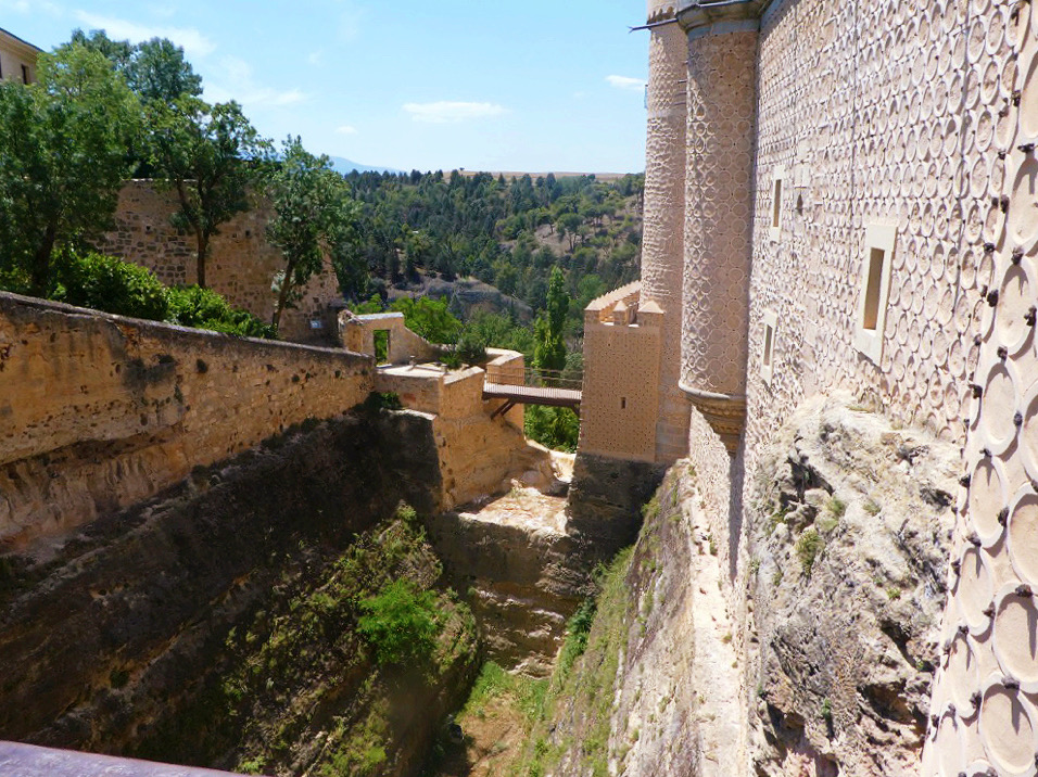 wooden drawbridge over a dry moat at the entrance of the alcazar of segovia
