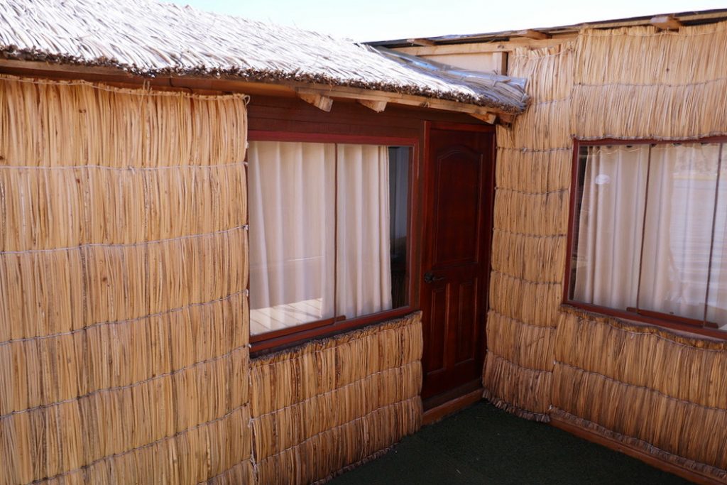 door and shaded window on a totora reed house in the floating islands of uros