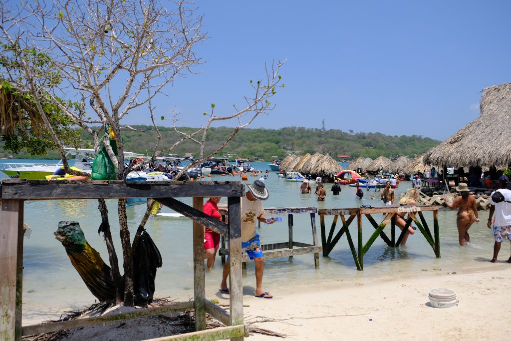 water tables standing on the shore in front of the ocean bar in cholon on one of the stops of a rosario islands day trip boat tour